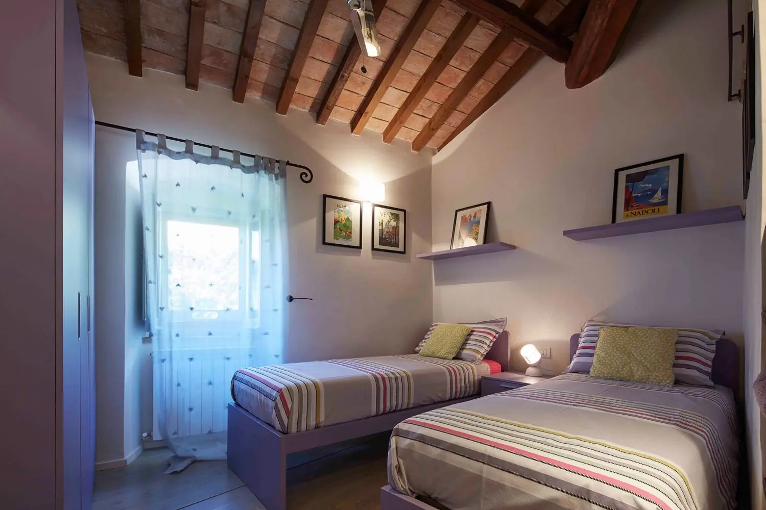 Bedroom with two single beds under a beamed ceiling