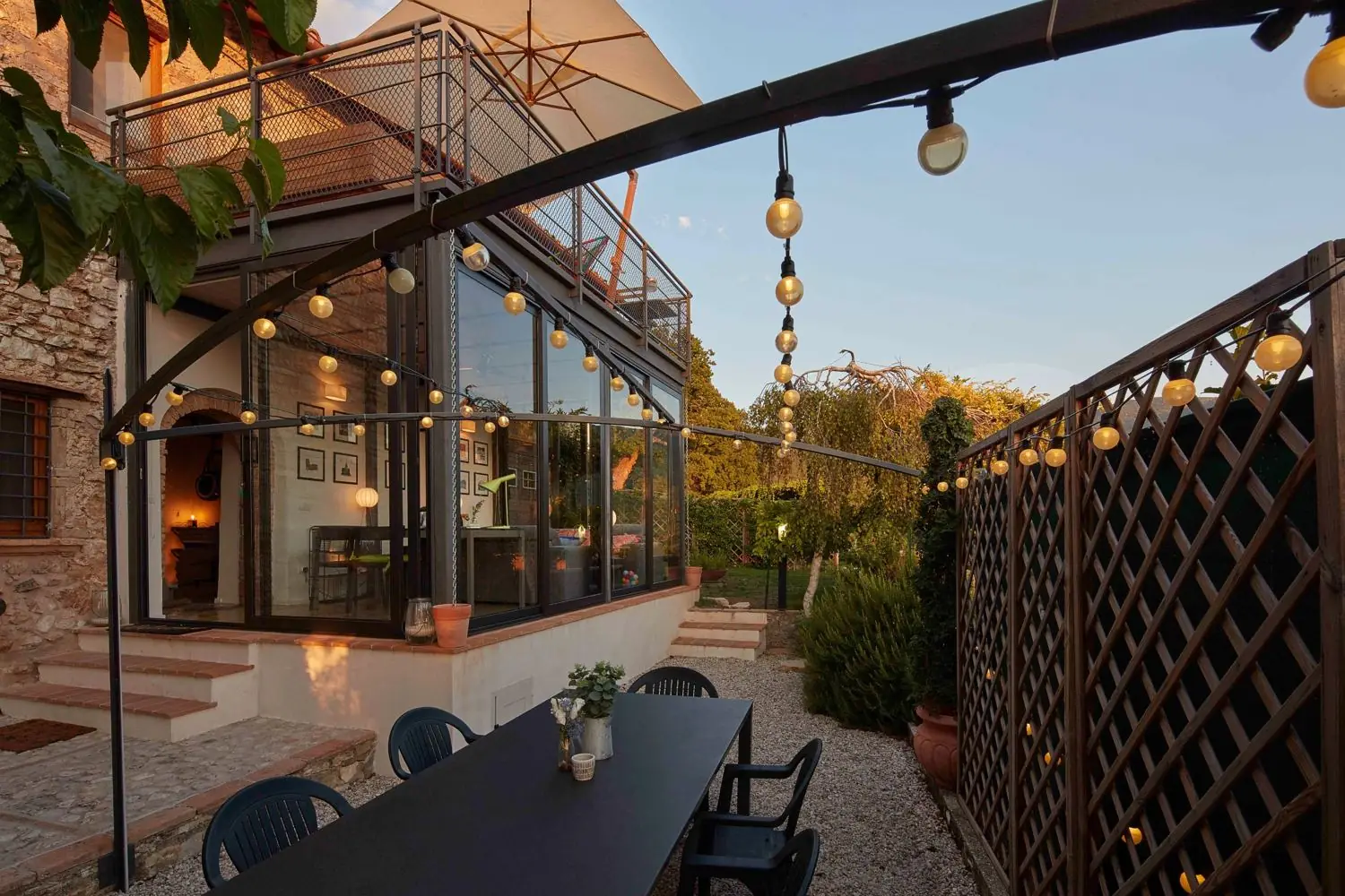 The stone house and glass winter garden at golden hour